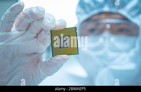 Science Technology. An engineer or scientist examining the computer CPU. Modern hi-tech digital technology concept. Stock Photo