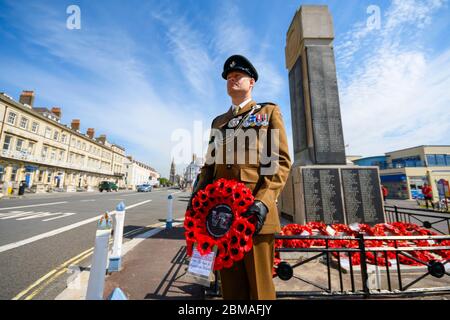 Weymouth, Dorset, UK.  8th May 2020. A two minutes silence and wreath laying at the War Memorial on the seafront at Weymouth in Dorset for the 75th anniversary of VE Day.  Major Nathan Howard holding the wreath ahead of laying it during the coronavirus lockdown.  Picture Credit: Graham Hunt/Alamy Live News Stock Photo