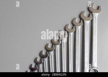 Spanners. Many wrenches. Grey background. Set of wrenches in different sizes on grey background. Top view with copy space. Stock Photo