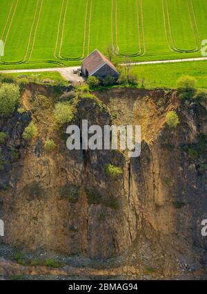 , Barn building on the edge of a quarry and gravel Thuelen GmbH in Brilon, 11.05.2017, aerial view, Germany, North Rhine-Westphalia, Brilon