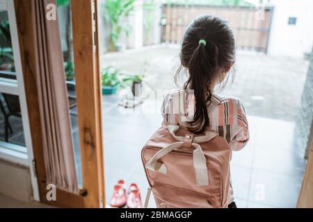 little girl going to school shoot from behind Stock Photo