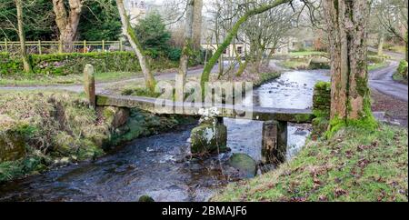 An ancient clapper bridge over Wycoller  Beck in Wycoller Country Park, Pendle, Lancashire, England Stock Photo