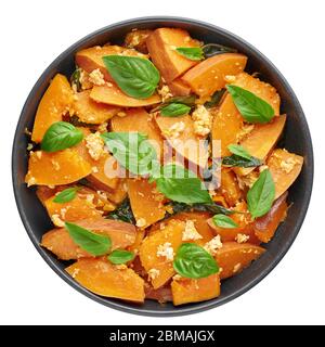 Pad Faktong or Thai Stir-fried Pumpkin in black bowl isolated on white background. Pad Phuk Tong is thailand cuisine dish with sliced Kabocha Squash, Stock Photo