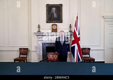 Prime Minister Boris Johnson observes a two-minute silence in Downing Street in London, to mark the 75th anniversary of VE Day. Stock Photo