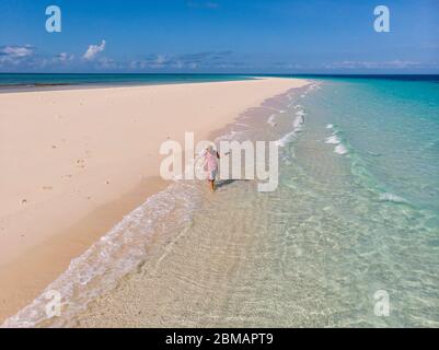 Traveller on Zanzibar. Empty beach at Snow-white sand bank of Nakupenda Island. Appearing just a few hours in a day. Aerial drone shot Stock Photo