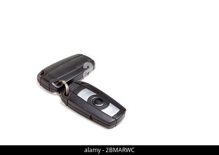 Car key, a second-hand keychain with a chip and with buttons for opening and closing the central locking control, isolated on a white background in a Stock Photo