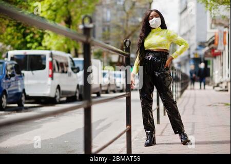 African American woman posing with facial mask to protect from infections from bacteria, viruses and epidemics. Stock Photo