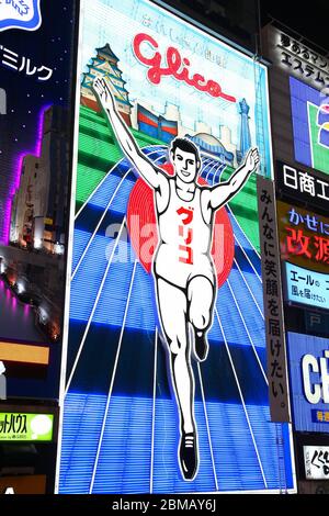 OSAKA, JAPAN - APRIL 24, 2012: Glico Man neon in Osaka, Japan. Existing since 1935, Glico Man is one of most recognized neons worldwide. Stock Photo