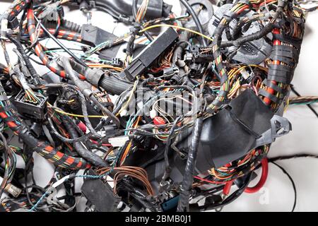 Ball woven multi-colored  wires and cable channels with rewound insulation and connectors on a white background. Problem engineer and system administr Stock Photo