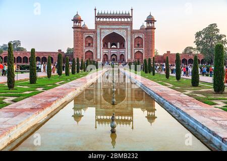 Looking away from the Taj Mahal towards the main south gateway across the pool of the gardens, Agra, India Stock Photo