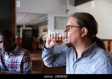 Caucasian man tasting beer in a brewery Stock Photo