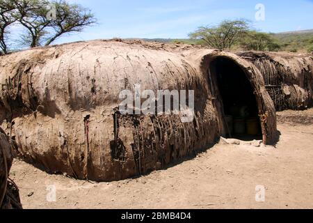 Traditional Maasai (Masai) hut is constructed from applying mud to a lattice framework of reeds Photographed in Kenya Stock Photo