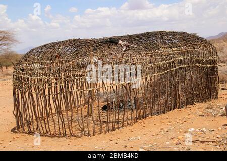 Traditional Maasai (Masai) hut is constructed from applying mud to a lattice framework of reeds Photographed in Kenya Stock Photo