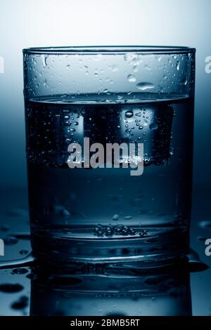 Cold water with ice cubes. Close up , toned Stock Photo