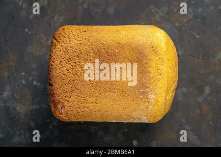 Fresh fragrant bread against a dark background. Assortment of baked bread on dark table background. Fresh fragrant bread on the table. Top views Stock Photo