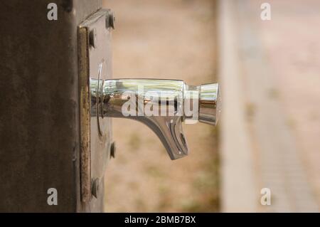 Close-up of contemporary tap of a street fountain in a park Stock Photo
