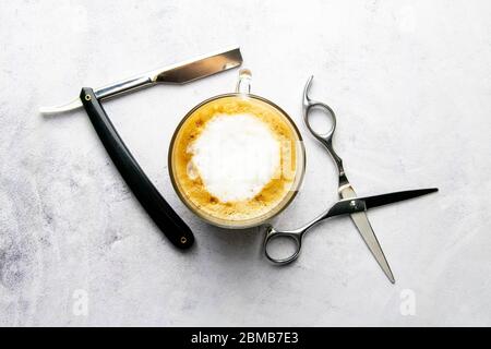 Men's Grooming Tools. Barber Equipment And Supplies Dangerous razor, coffe and scissors on marable background. Top views, close-up Stock Photo
