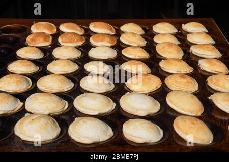 https://l450v.alamy.com/450v/2bmb7pj/typical-dutch-poffertjes-tiny-pancakes-being-baked-on-a-heavy-cast-iron-pan-being-prepared-during-street-food-festival-an-outdoor-event-traditiona-2bmb7pj.jpg