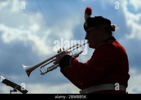 Dudley, UK. 8th May, 2020. Trumpeter Sam Chater, 35, of the band of the Royal Regiment of Fusiliers, Warwickshire, plays the Last Post outside her home in Dudley, West Midlands, UK. Credit: Peter Lopeman/Alamy Live News Stock Photo