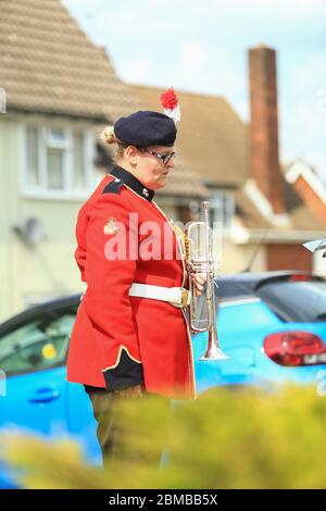 Dudley, UK. 8th May, 2020. Trumpeter Sam Chater, 35, of the band of the Royal Regiment of Fusiliers, Warwickshire, plays the Last Post outside her home in Dudley, West Midlands, UK. Credit: Peter Lopeman/Alamy Live News Stock Photo