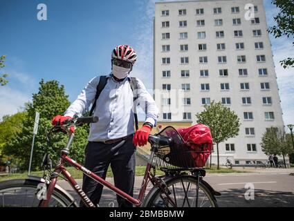 08 May 2020, Saxony-Anhalt, Halle (Saale): Karamba Diaby, SPD member of the Bundestag from Halle/Saale, is standing in front of a high-rise building in which he once lived as a student on the eighth floor. Diaby is walking through Halle/Saale on volunteer day with his supporters from the local associations to collect garbage. He is here to do something for society on Volunteers' Day, said the Senegalese-born, PhD chemist. Diaby had recently hit the headlines nationwide after bullet holes were found in his citizens' office. Photo: Hendrik Schmidt/dpa-Zentralbild/ZB Stock Photo