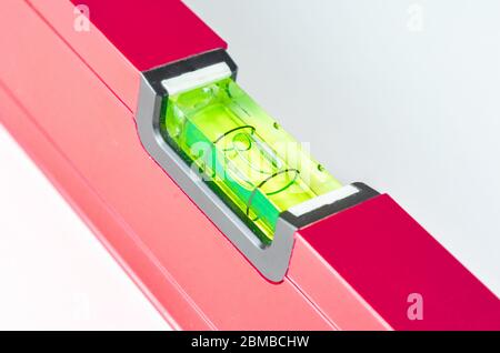 Close-up  of   red   Spirit Levels  used in construction on white  background  . Stock Photo