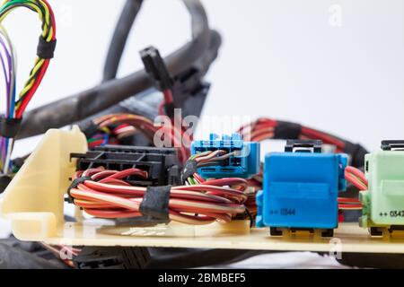 Close-up of a blue connector and a red power channel against a background of tangled wires and digital channels. Connecting Internet network of an IT Stock Photo