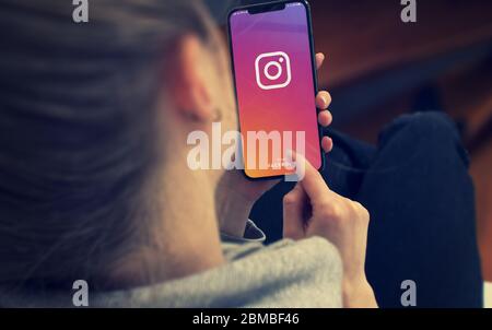 KYIV, UKRAINE-JANUARY, 2020: Instagram on Smartphone Screen. Young Girl Pointing or Texting Smart Phone During a Pandemic Self-Isolation and Coronavirus Prevention. Stock Photo