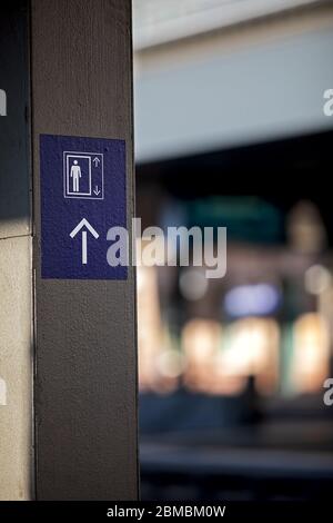 icon with human figure and arrows showing the way to the next elevator Stock Photo
