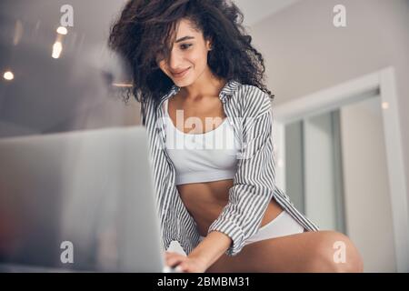 Young woman staring at the laptop screen Stock Photo