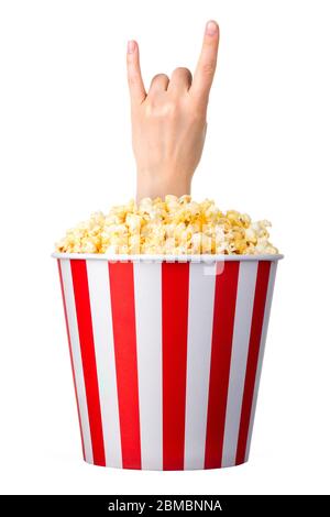 Female hand sticks out of a bucket with popcorn isolated on white background Stock Photo