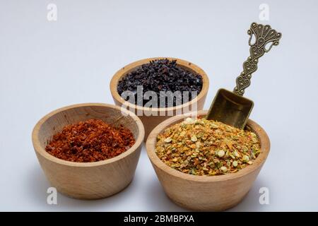 Turkish style pepper powders in the bowls with a metal spoon Stock Photo