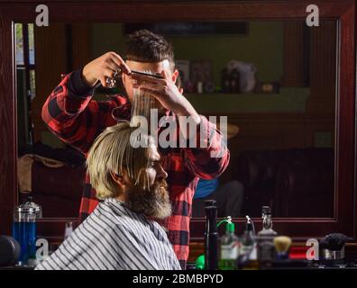 Donate hair. Sharp object near face and squirming distracts person holding it. Donation and charity concept. Guy with dyed blond hair. Cut hair. Barber hairstyle barbershop. Hipster getting haircut. Stock Photo