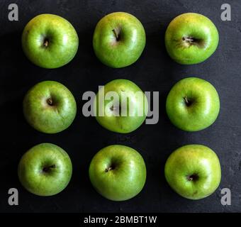green apples aligned ordinates isolated on black background tic tac toe Stock Photo
