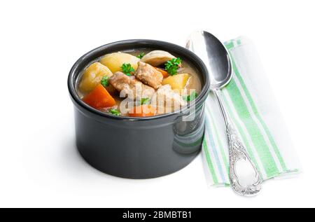 Stewed  pork with vegetables in small clay pot isolated on white Stock Photo