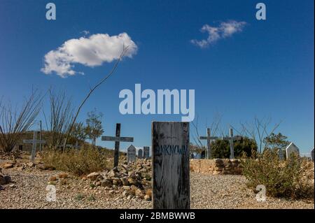 Old unknown graves in boot hill cemetery blue sky and cloud above Stock Photo