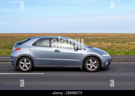 2008 blue Honda Civic ES I-VTEC S-A; Vehicular traffic moving vehicles, driving vehicle on UK roads, motors, motoring on the coast road at Southport, UK Stock Photo