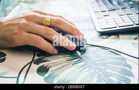male hand handling a computer mouse Stock Photo