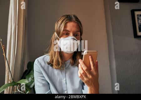 Woman with a mask shows her concern in times of Covid-19 Stock Photo