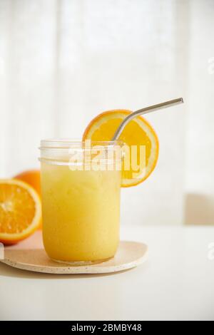 Refreshing Orange Juice with Metal Straw Stock Photo
