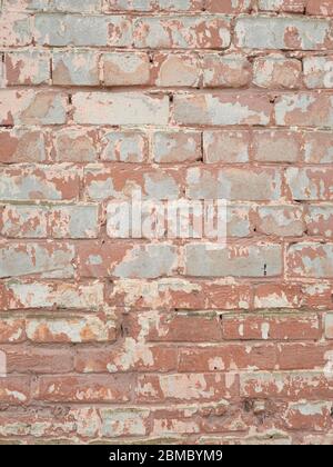 old brick wall of red brick and with cracks scuffs Stock Photo