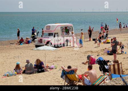 Holidaymakers enjoying a day on Hemsby beach.  Hemsby, Great Yarmouth NR12 9BX Stock Photo