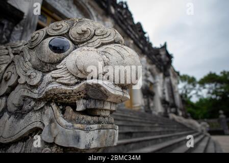 Hue, Vietnam - April 16, 2018: Dragon's head at the Emperor Khai Dinh tomb, with no people and an overcast sky Stock Photo