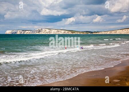 People enjoying the surf at Compton Beach on the Isle of Wight Stock Photo