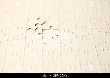 puzzle with missing piece - solution concept. plan white puzzle surface texture with copy space. Stock Photo