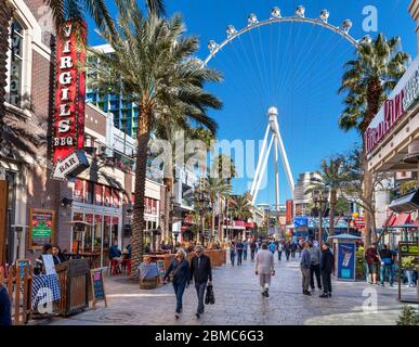 Shops, bars and restaurants on The Linq Promenade looking towards the High Roller ferris wheel,  Las Vegas Strip, Las Vegas, Nevada, USA Stock Photo