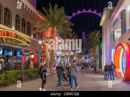 The Linq Promenade at night. Shops, bars and restaurants on The Linq Promenade looking towards the High Roller ferris wheel,  Las Vegas, Nevada, USA Stock Photo