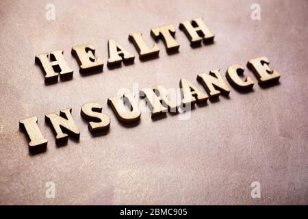 Health insurance text on a colored paper. Stock Photo