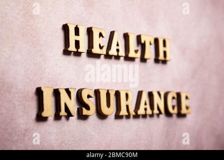 Health insurance text on a colored paper. Stock Photo