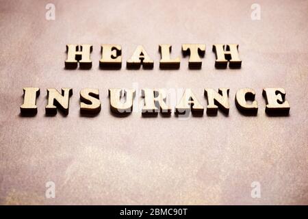 Health insurance text on a colored paper. Stock Photo